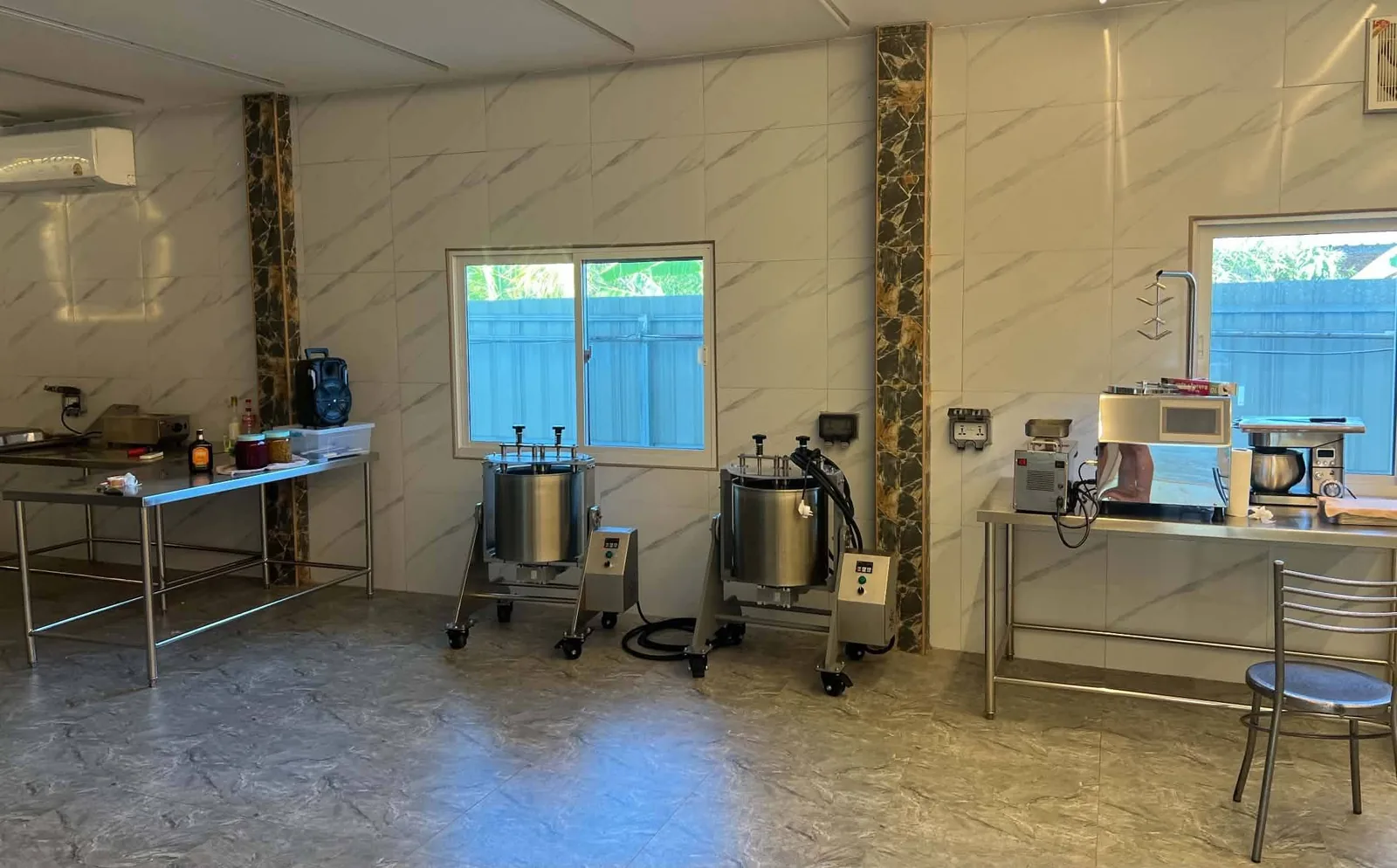 Inside the Dragon King Chocolate production room in San Kamphaeng with stainless steel equipment along the wall
