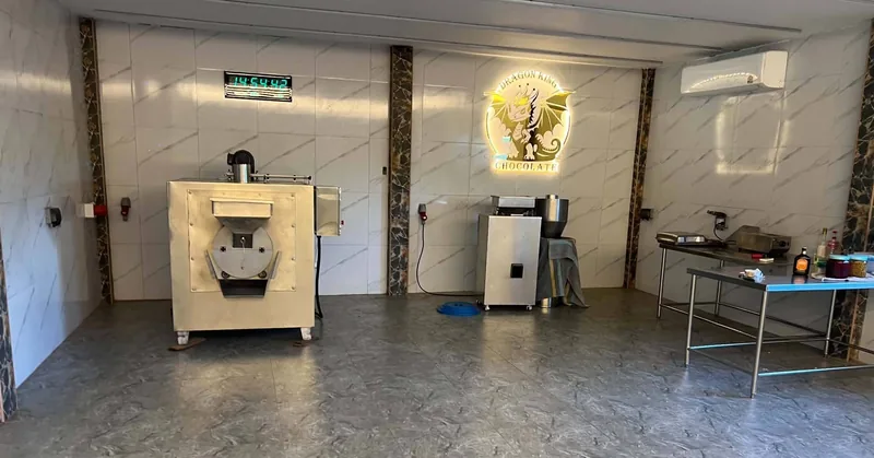 The roasting room at the Dragon King Chocolate facility in San Kamphaeng with a bean roaster and work tables
