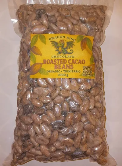 Vacuum-sealed bag of Dragon King Chocolate roasted cacao beans with a gold label